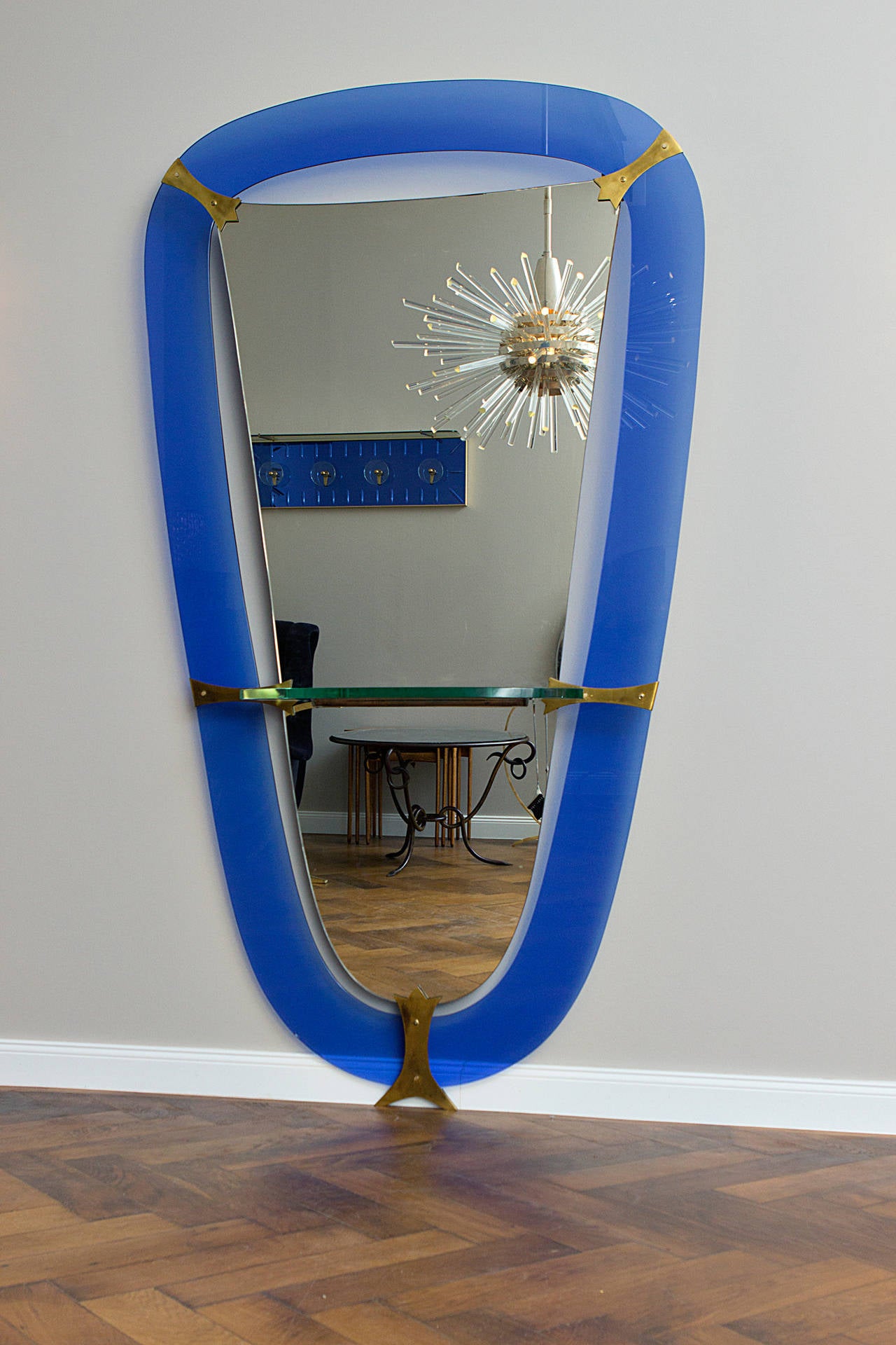 Rare Cristal Art mirror Italy circa 1950, Prod. Cristal Art, blue glass, joints in polished brass, shelf wooden frame, mirrored glass. 
Height 217 x length 122 x depth 25 cm