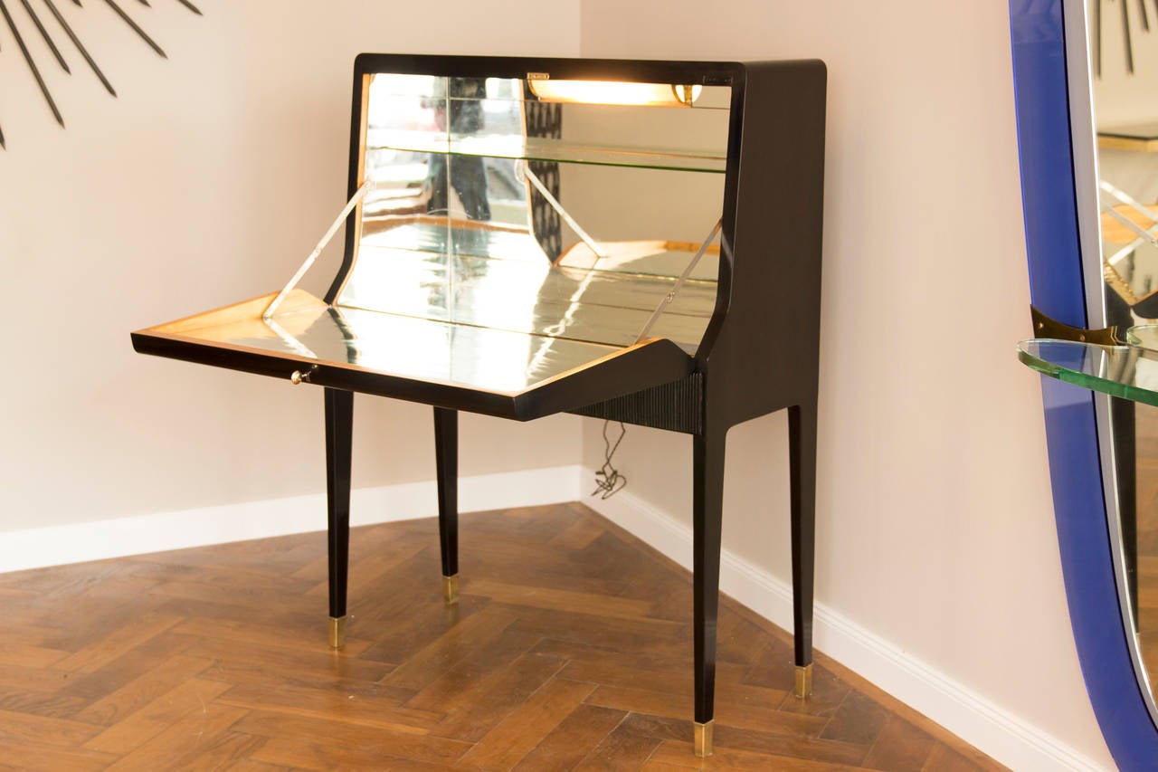 Rare bar cabinet, France, circa 1945.
Shellac polished wood, incorporated rivets buttons star-shaped on the front door, original old mirror glass inside, interior lighting, brass feet, brass key, two front drawers, new restoration. 
Measures: