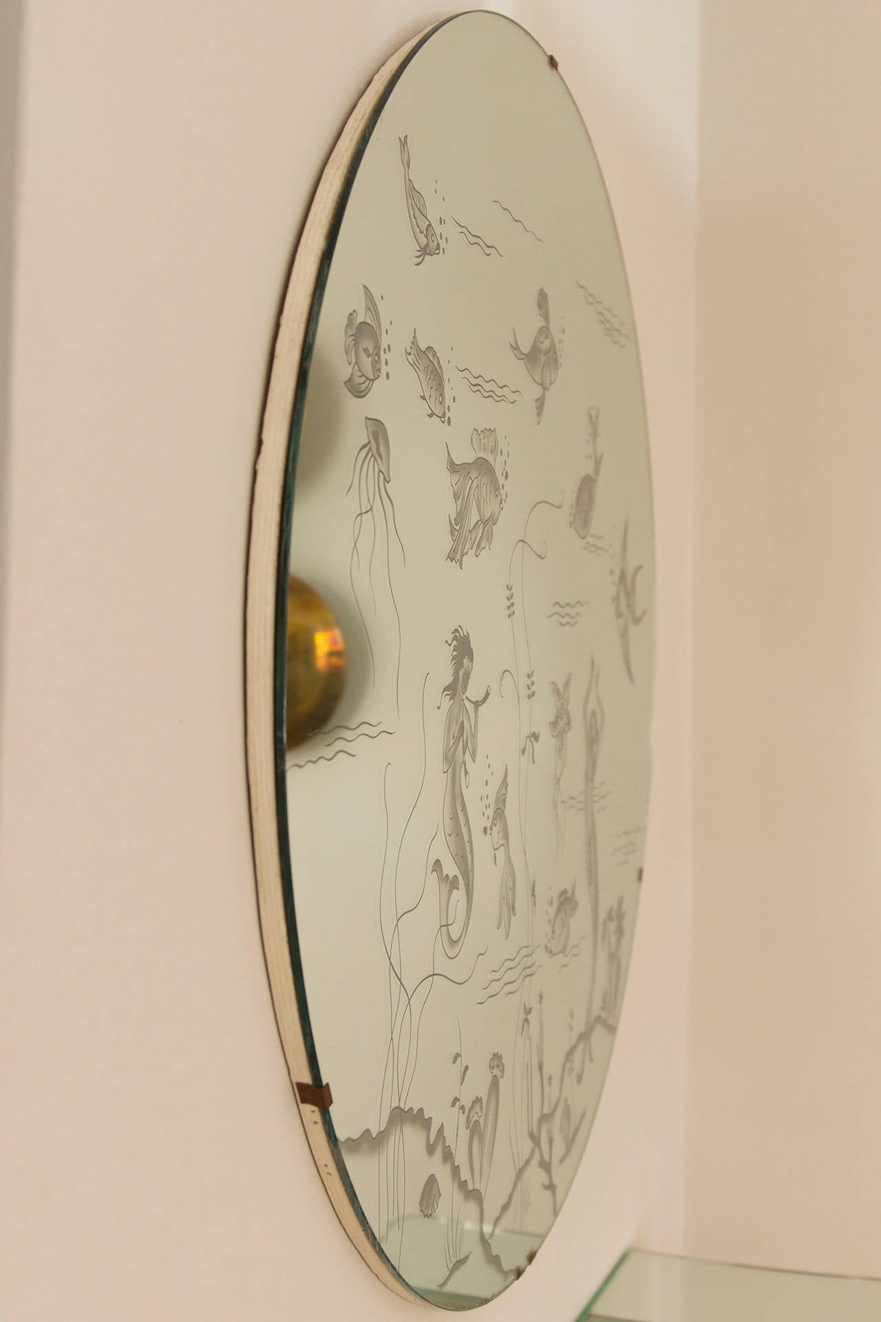 Rare Mirror in the style of Gio Ponti, Italy circa 1955, engraved Ocean pattern like fishes, mermaids, seagrass, jellyfish and sea shells. Mounted on white lacquered wood plate. Diameter 90 cm
