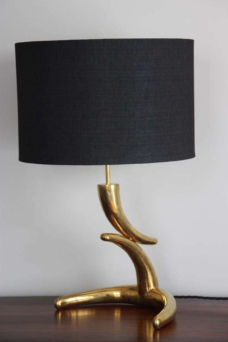 Very solid brass table lamp in an organic form, France, circa 1960, excellent condition, age appropriate wear with very nice patina, new black dupion silk shade, inside golden lacquered.