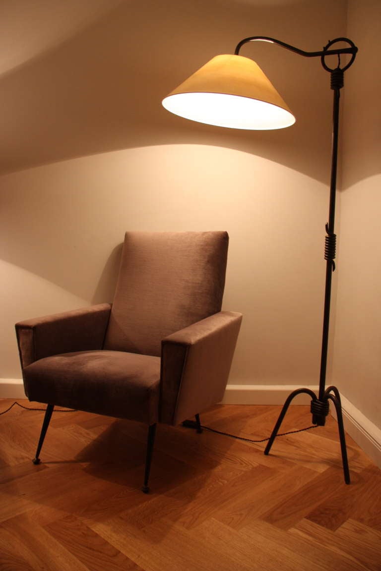 Jean Royère (1902-1981), France circa 1945, floor lamp with original patina, wrought iron stem, tripod base, adjustable arm offering different positions of lighting. Shade redone as the original in cream paper.

Height: from 185 - 150 cm
Diameter