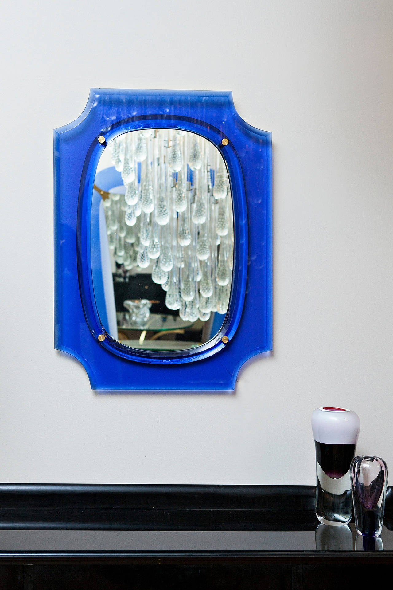 Elegant Wall mirror by Cristal Art, Italy circa 1970, blue shaped glass frame, mirror glass fixed with brass discs.
Height 80 cm, width 60 cm, depth 4 cm
Perfect condition!