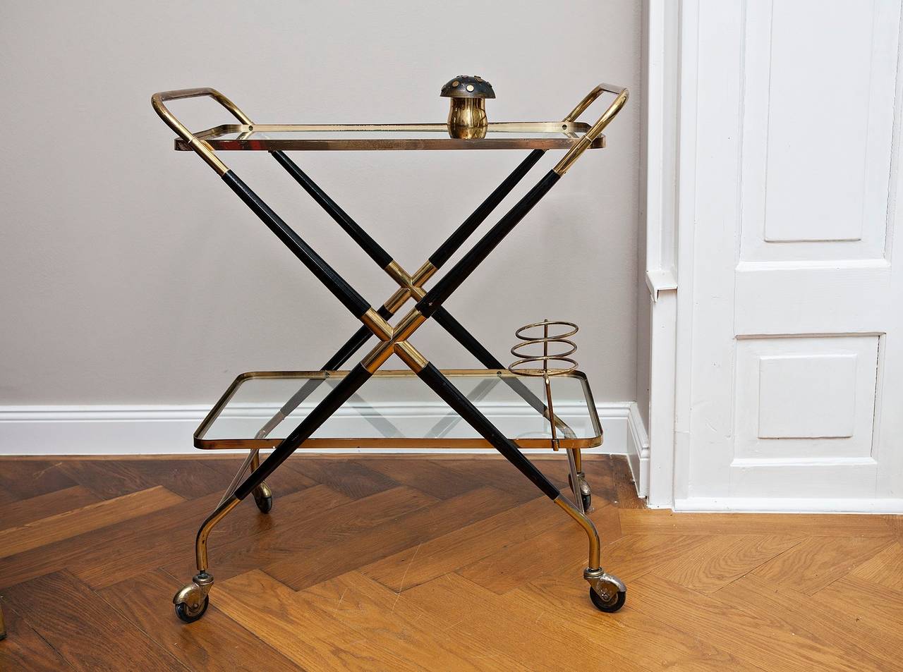 Beautiful bar cart by Cesare Lacca, Italy circa 1960, high quality bar trolley made of brass and black lacquered wood with removable glass trays,bottle cage  
The cart  can be folded for easy storage.