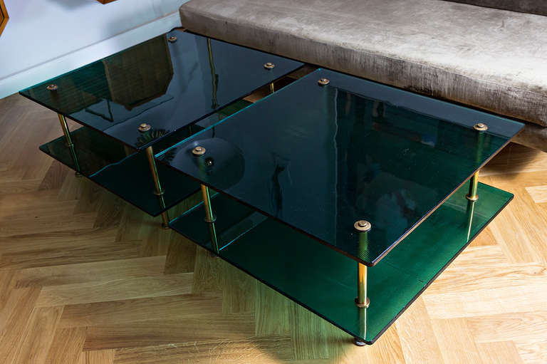 A pair of very rare Raphael sofa / coffee tables, Prod. Raphael Furniture Paris France, circa 1960, to floors of green colored glass by Saint Gobain, content of brass rods. Each table height 40 cm, width 80 cm x 80 cm, diameter 110 cm, first floor