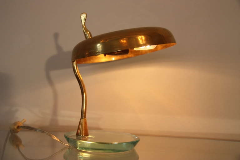 Very nice italian table lamp, attr. to Fontana Arte, Italy circa 1950, brass shade, glass bottom.  The brass shade is swivel in two directions, brass socket, brass knob, perfect patina.