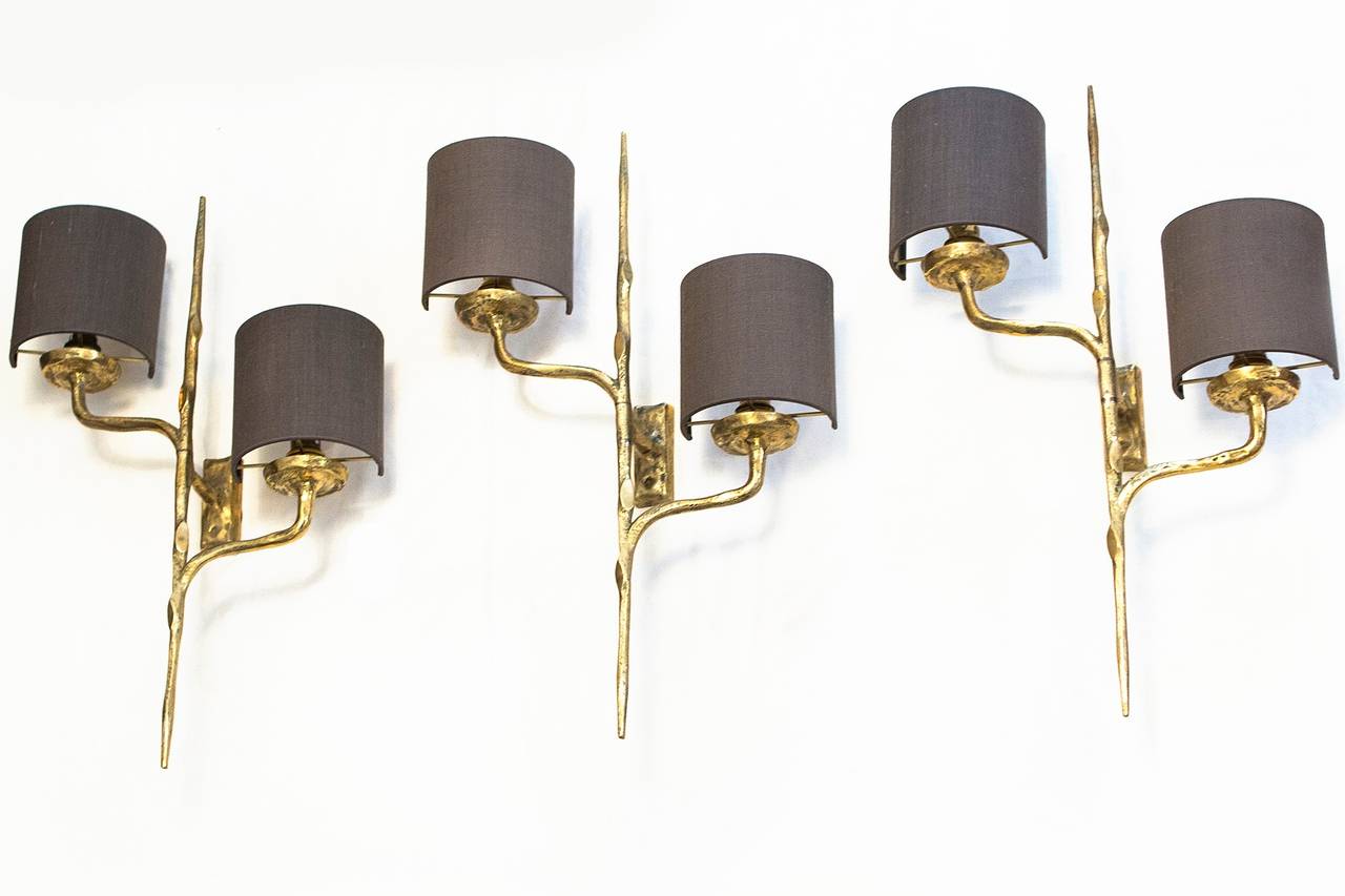 Three of cast gilt bronze sconces by Felix Agostini, French circa 1960, gilded bronze, bayonet mount, new brown bronze color  Dupion silk shades inside gold.
Perfect original condition, nice patination.
Length 51 cm, width 32 cm, depth 12 cm,