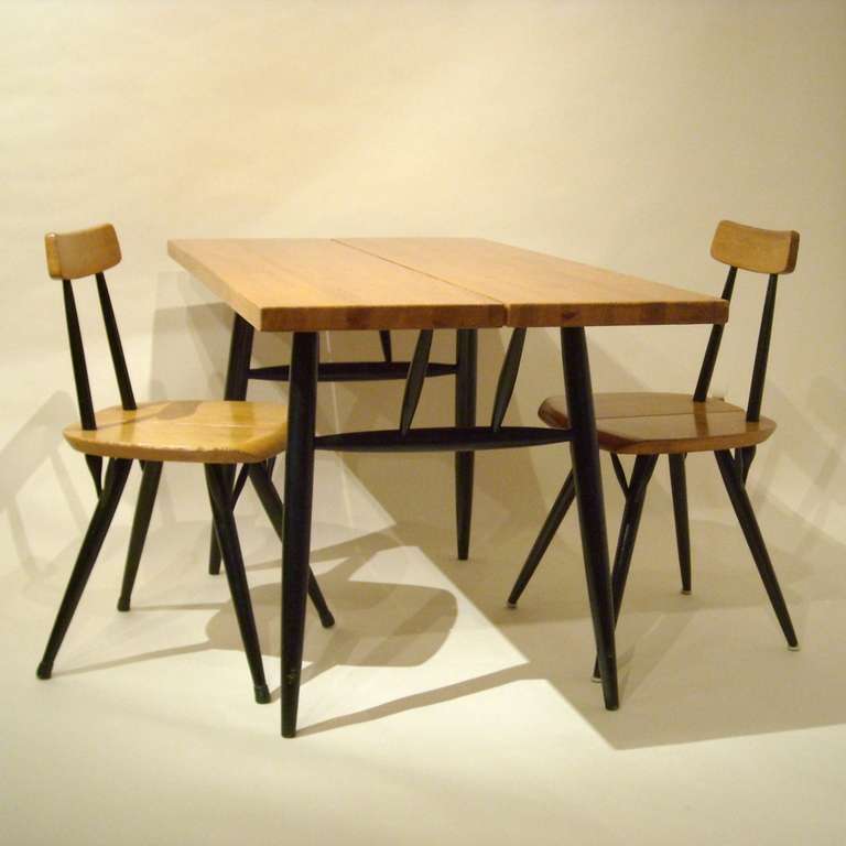 This early Pirkka ensemble was designed in 1955 by Ilmari Tapiovaara
and produced by Laukaan Puu Finland
black painted solid legs, pine table top
table with  2 chairs, all items branded with 