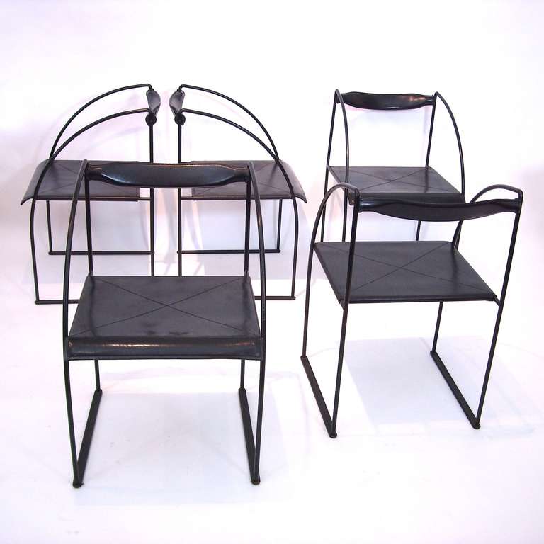 Multi-purpose chairs with steel rod structure painted in black. Seat ad swivel backrest in saddle leather  with visible stitching. These chairs are originals from the 1980ies and show purity of lines and lightness. They were designed in 1981 by