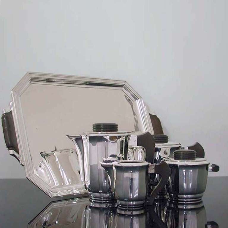 Silvered metal tea/coffee service, around 1920

Comprised of a rectangular tray, no. 45; coffeepot, no. 25; teapot, no. 25; covered sugar, no. 15; and open creamer, no lid, no. 10; all with makassar handles, hollowware marked Frionnet Francois on