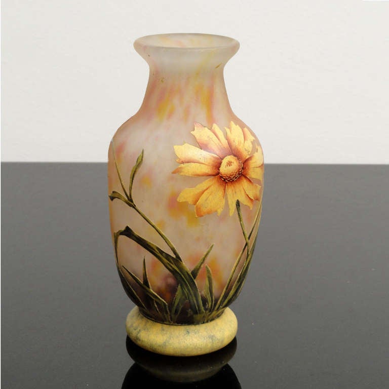 Colorless cameo glass, inner and intermediate layer with flaky inclusions in rosé, red, yellow, white and green, all-round in relief etched matt enamelled multi-colored. Circular decoration of flowers and leaves. Signature on the wall: DAUM NANCY