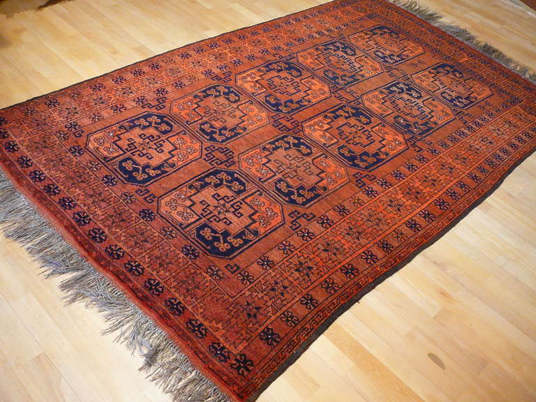 Beautiful vintage Ersari rug from the Afghansitan / Turkmenistan border area. The design is strongly influenced by Afghan rugs, but the very fine weave and silk like wool is more common to turkmen rugs. The colors are rust-red, rust-orange, dark