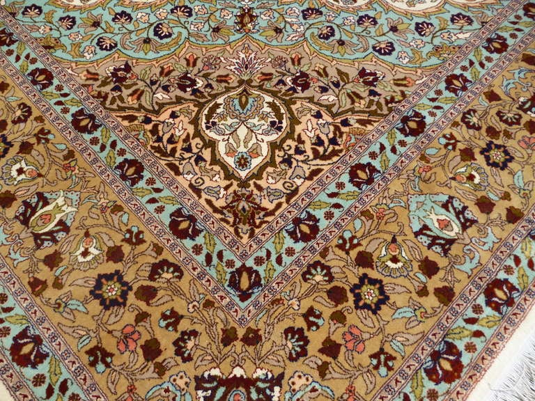 Elegant formal rug from the City of Hereke in Turkey. Very large size for a rug this fine. Light interior field and floral design make a nice contrast with bronze Medaillon and border. This semi antique carpet is in a very beautiful high pile