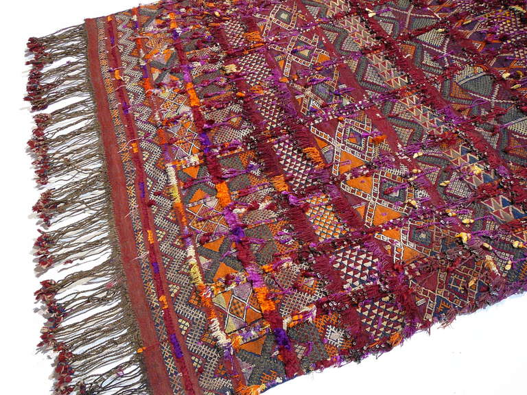 Antique north african berber wedding blanket. This is the finest woven wedding blanket we have ever had. Handwoven from very fine wool and knotted motives made from silk and cotton. Small metal plates on the fringes made the bride glitter in the