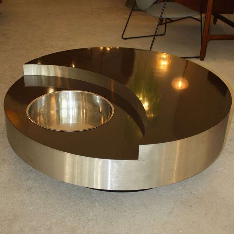 Revolving table/ bar, designed by Willy Rizzo, France, 1971. DARK BROWN laminate surface, brushed metal surround and polished stainless steel bowl insert. AMAZING!

The compact 114cm model of the table.