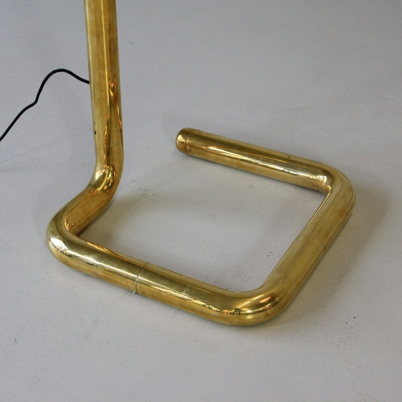 Arc lamp of the 1970s, France.

Metal base and arm in gold/brass colored with perspex shade.