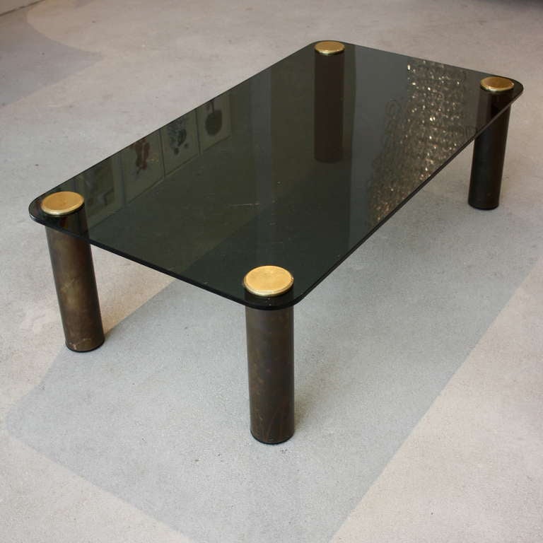 Coffee table by PACE COLLECTION. Thick green glass surface with four cylindrical brass legs, topped with brass caps. U.S., 1970's.