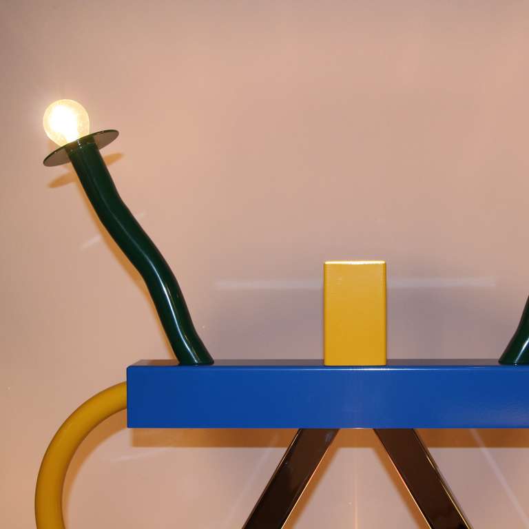 Ashkoa table lamp, designed by Ettore Sottsass in 1981.
Metal construction, lacquered in different colours. Marked Memphis.

The ‘Ashoka’ table lamp is one of the of several lamp designs produced by Ettore Sottsass for Memphis. In form this is