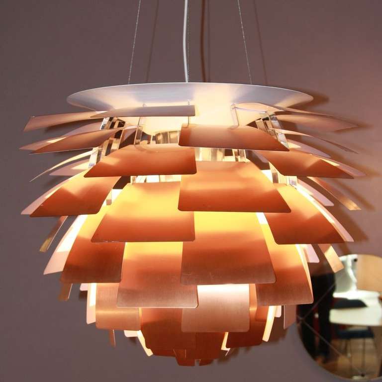Poul Henningsen designed the PH Artichoke light in 1957. This particular lamp dates back to the1980's and is in great condition. It is made of 72 pieces of overlapping copper leaves with a reflective creme finish to the interior, spreading a warm