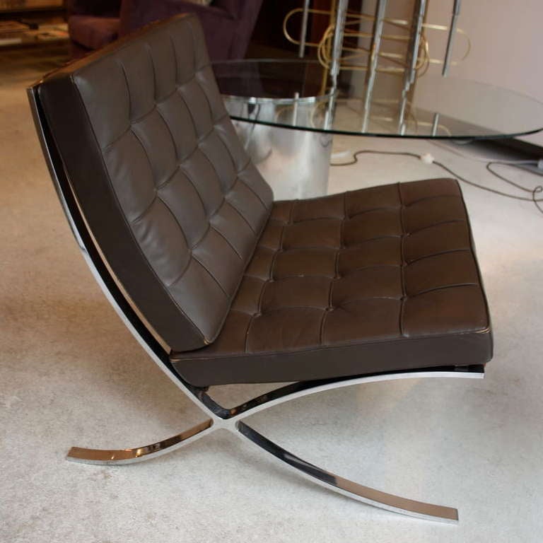 Chocolate brown, buttoned leather-upholstered cushions and bent chromed steel frame with leather straps. Ludwig Mies van der Rohe, in collaboration with Lilly Reich designed this lounge chair for the German Pavilion (1929 World Exhibition held in