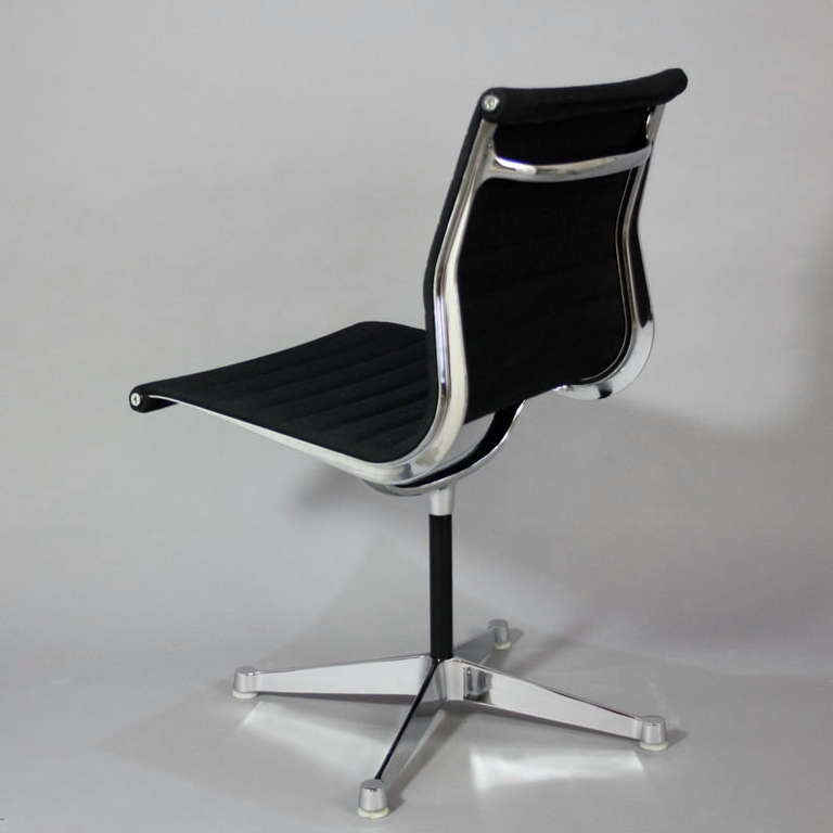 Aluminium group chair EA105 with four star base and swivel version designed by Charles Eames in 1958. Base in die-cast aluminium, chrome-plated. Upholstered in black hopsak. Herman Miller (with label), 1980s.