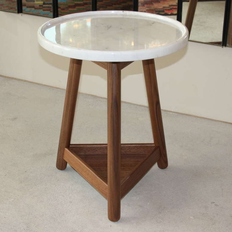 A generous marble-topped table with a carved rim on a solid wood base with turned legs designed my Bethan Gray.

Marble marked.