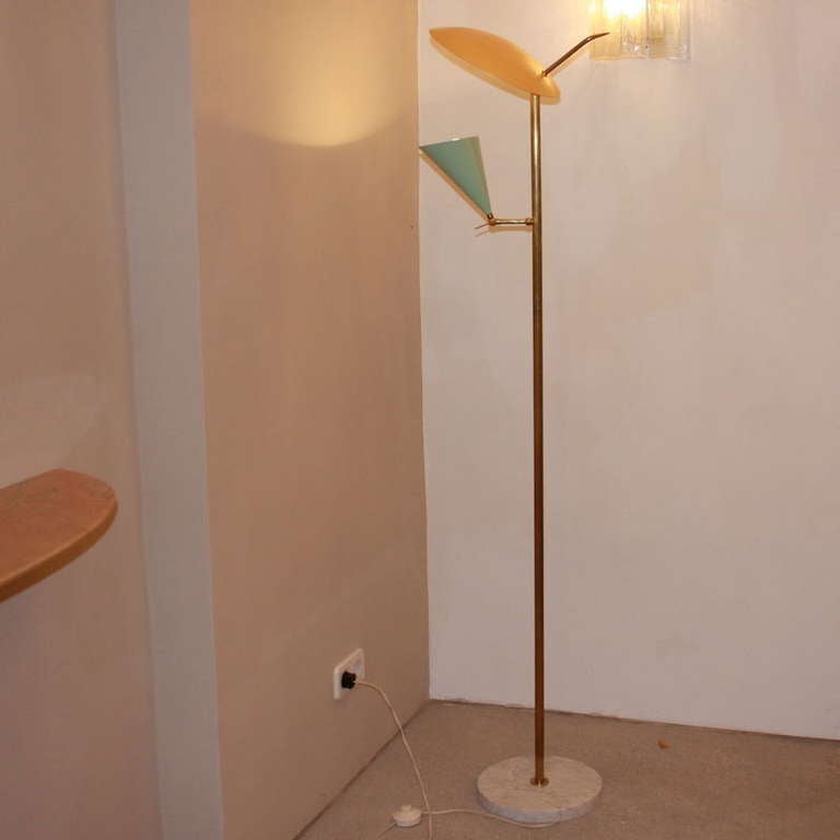 Arteluce floor lamp with brass stem and brass arms. Two metal shades in light green and yellow. ITALY, 1950's.