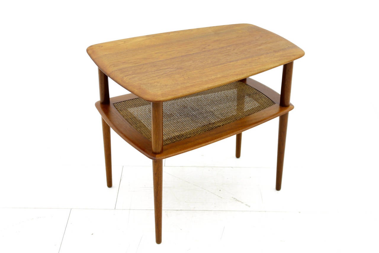 Beautiful side or end table by Peter Hvidt & Orla Molgaard Nielsen, produced by France & Daverkosen. 
Solid Teak Wood and Cane.
Very good condition.

Worldwide shipping.