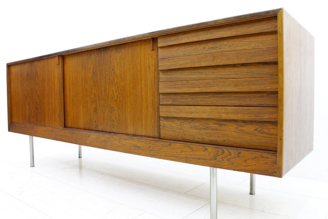 Rosewood sideboard or credenza with metal legs by Kurt Ostervig for K. P. Mobler, Denmark.
Two sliding doors and four drawers.
Very good condition.

Worldwide shipping.