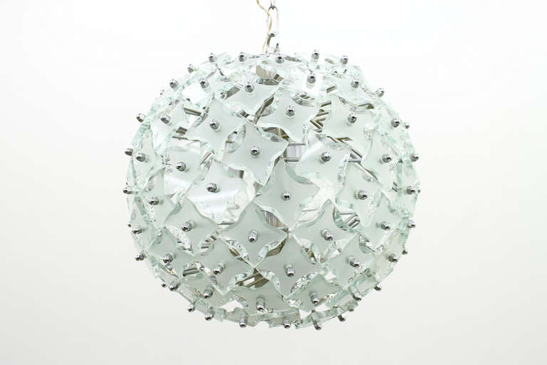 Glass and metal chandelier, Italy 1970s. Fantastic geometric chromed frame inside.

Measures: Diameter 38 cm, height with chain 98 cm.

Very good condition

Details

Creator: in style of Fontana arte
Period: circa 1960s
Color: silver
Style: