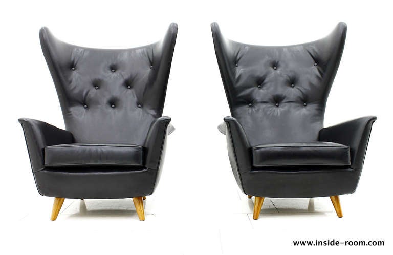 Fantastic Wing Lounge Chairs from the early 50s. 
Newly upholstered and covered in a Danish Manufacture with original fine Arne Sørensen Range Leather in black.
Two Chairs are available. 
Excellent Condition.