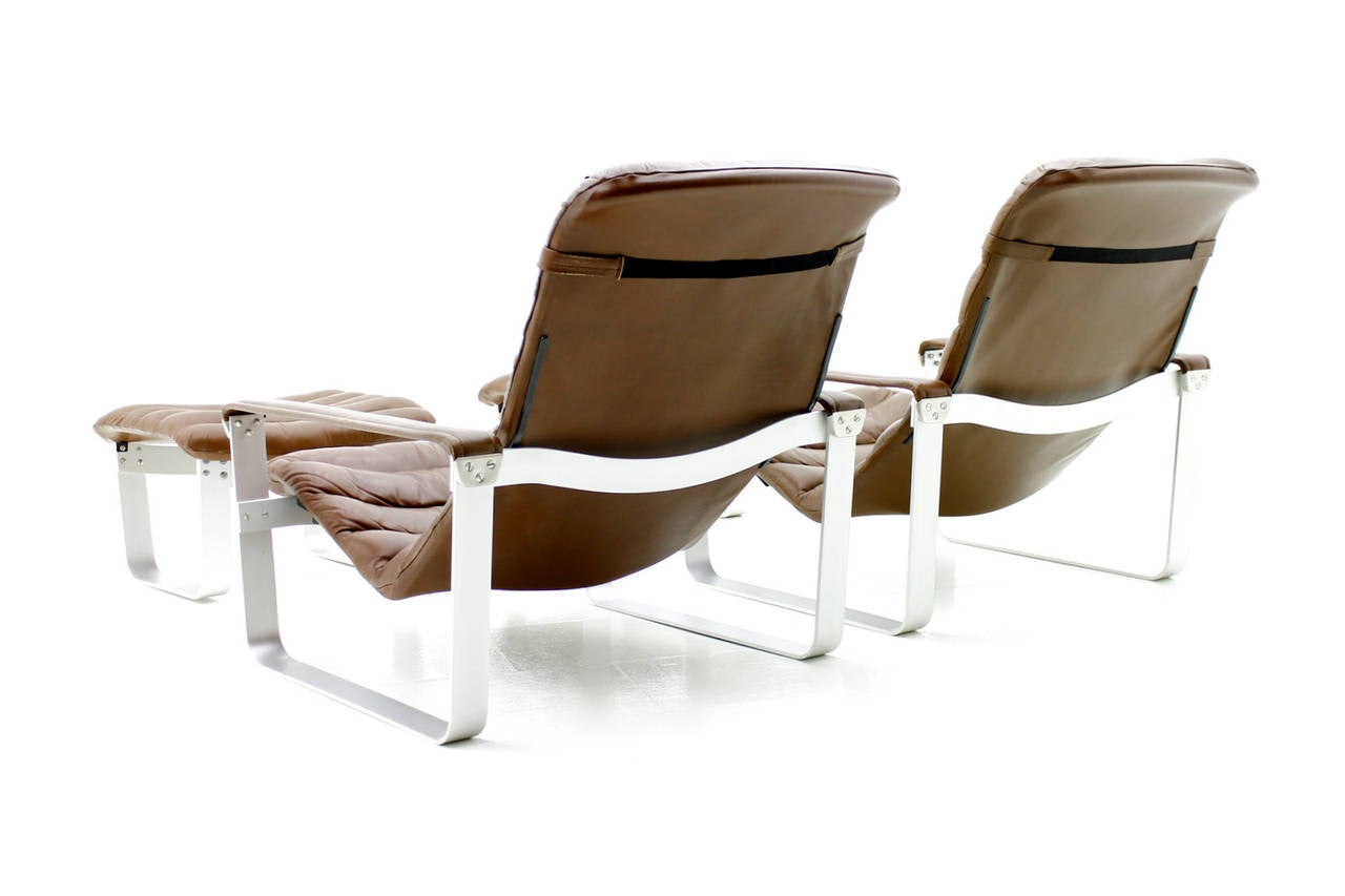 Pair Ilmari Lappalainen Lounge Chairs with Ottoman, Pulkka, designed in 1963 and made by ASKO.
Aluminium Base and chocolate brown Leather.
The Seating is adjustable.
Excellent Condition !

***One Chair is available ***

We offer a safe and