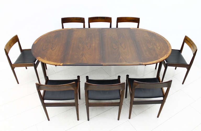 Rare Rosewood Dining Suite by Grete Jalk, Denmark.
Round Dining Table with two Extensions. 
Eight Rosewood Chairs with black Leather.
By Poul Jeppesen, Denmark

Table: Diameter 115 cm, + 2 x 54,5 cm, Height 73 cm.
Chairs: W 50 cm, H 75 cm, D