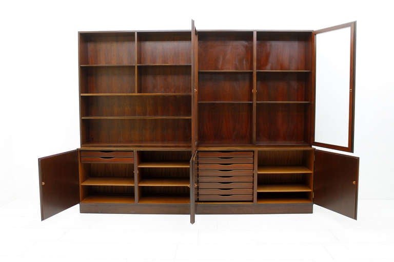 2 bookcases in rosewood by Oman Jun Model 11, ca. 1960s, Denmark.
In total, there are four elements. 2 lower units with doors and two upper elements, one with glass doors.
Great rosewood grain, wonderful original condition.
H 187 cm, D 44 cm, W 2