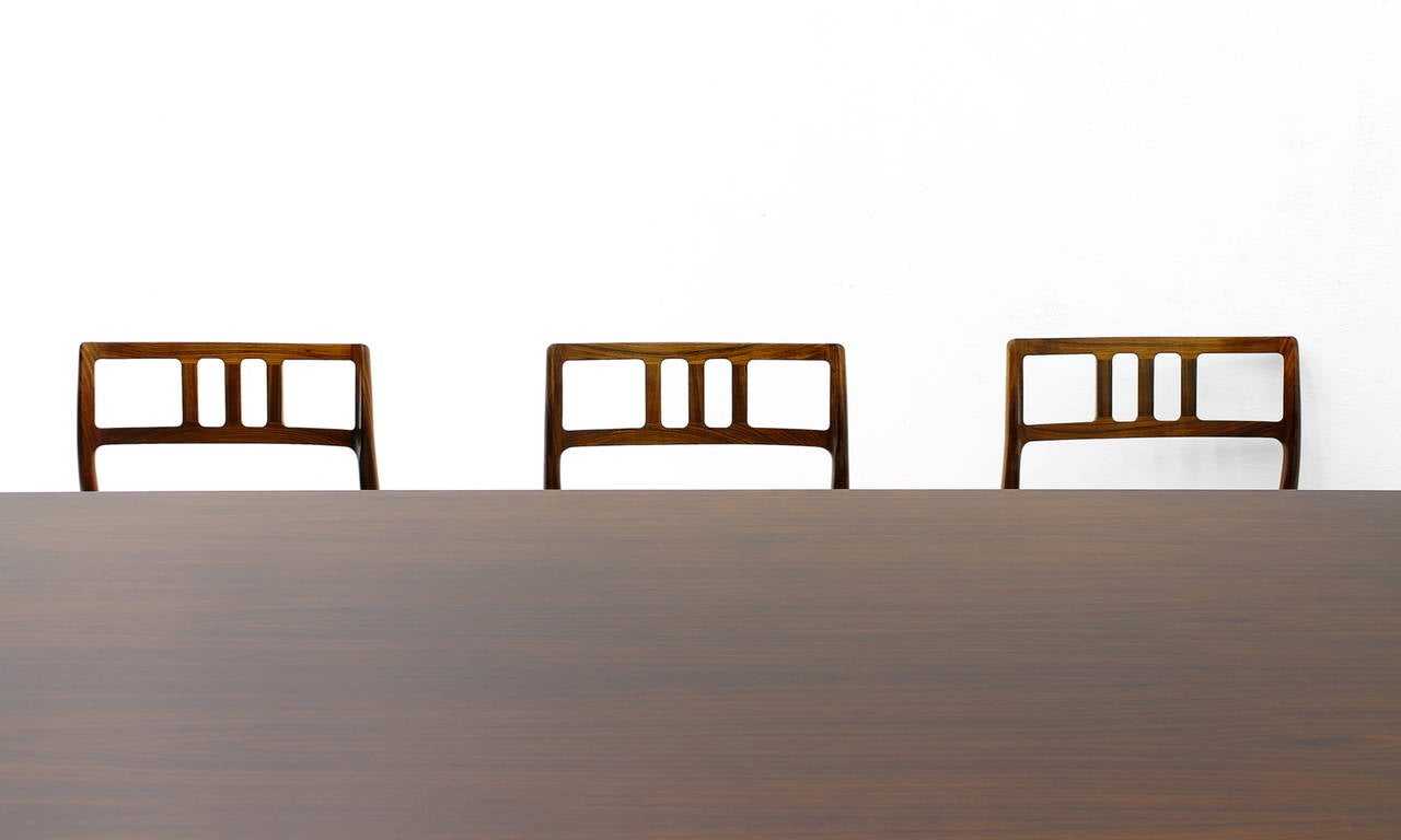 An exclusive Danish rosewood dining room set by Niels O. Møller, 1960s.
Set of eight chairs, six without and two with armrests in rosewood and black leather. A large matching dining table with two extensions in rosewood.
Made by J.L.