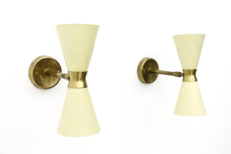 Great set of four wall sconces in two different sizes in lacquered metal and brass from the 50´s. Good original Condition.

Size: 
Small Lamps: H 23 cm, Depth 21 cm, DM 8 cm
Large Lamps: H 41 cm, D 24 cm, DM 12 cm

Worldwide shipping