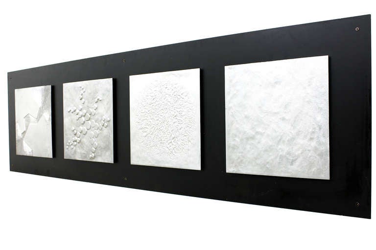 Beautiful Wall Decoration of a large black Metal Plate and four Cast Aluminum Plates with different Decors.

