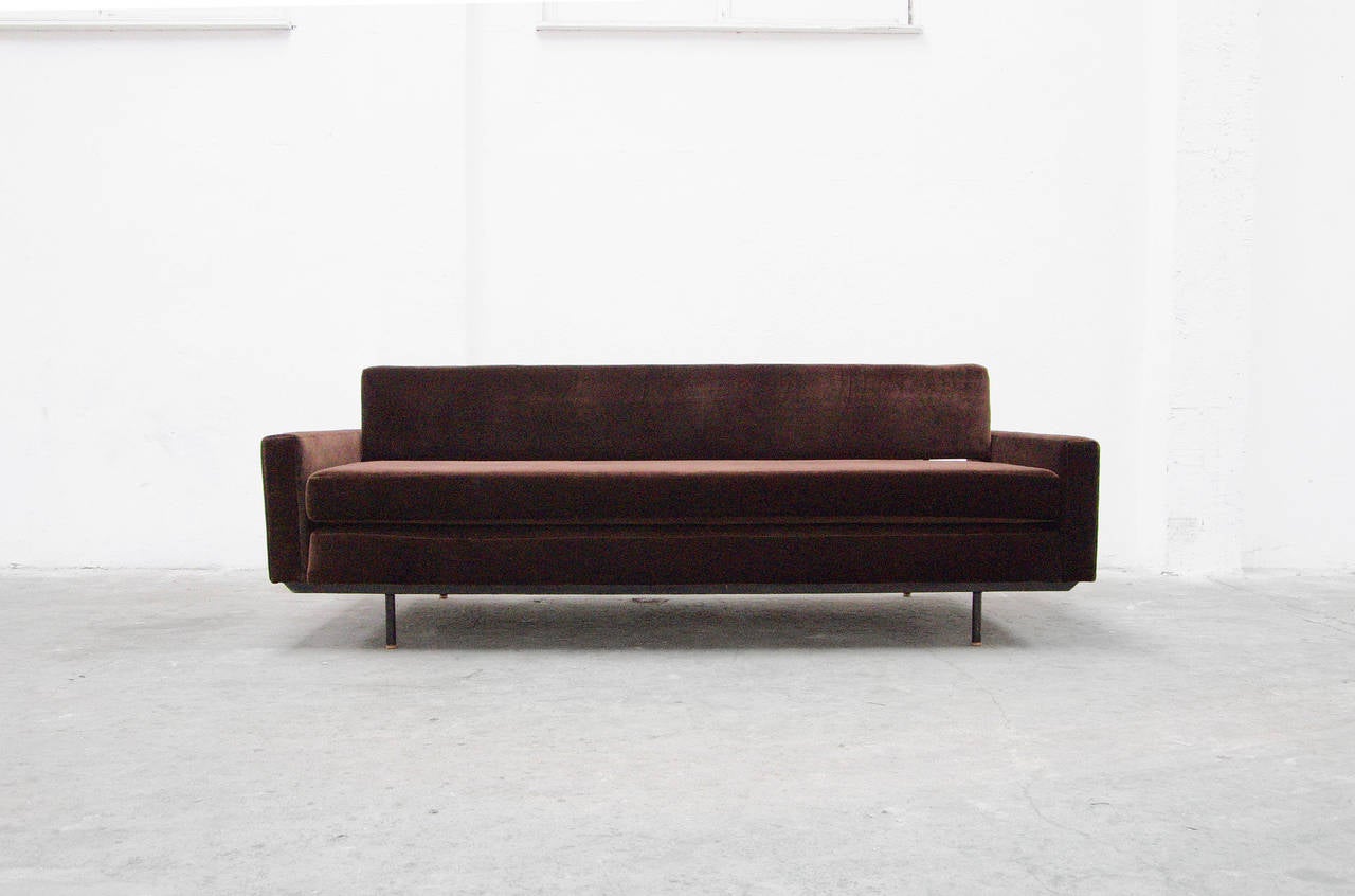 Florence Knoll's plush chocolate colored velvet sofa deigned with steel construction perfectly converts into day-bed. This multi-functional design transitions easily from one task to another with a few mere pulls, including an expandable backrest.