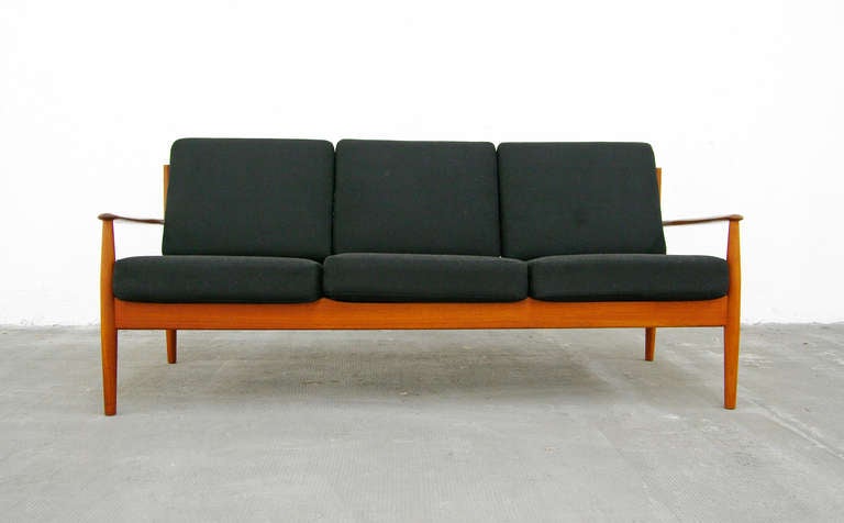 A classic teak sofa designed by Grete Jalk for Cado.
This sofa is one of the most popular designs to be manufactured in Denmark.
The design features a simple yet very strong external frame of solid teak which has a lovely warm hue to it.
The sofa