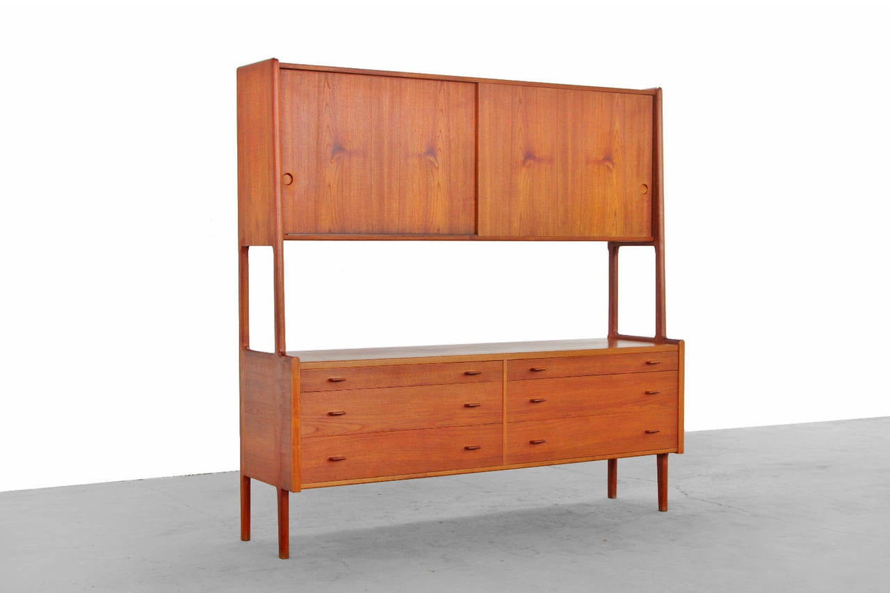 This gorgeous and versatile piece is one of the most popular Wegner designs.
With six drawers and two sliding doors above. 
Perfect storage solutions for any space - living or dining. 
In beautiful vintage condition.