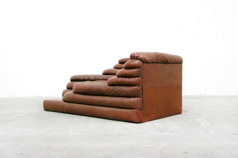 A rare seating section by Ubald Klug for De Sede 1973.
This oustanding topographical landscape design is world famous.
Very nice natural brown leather seats with nice patina due to years of usage.
On this piece was very fond of sitting and the De