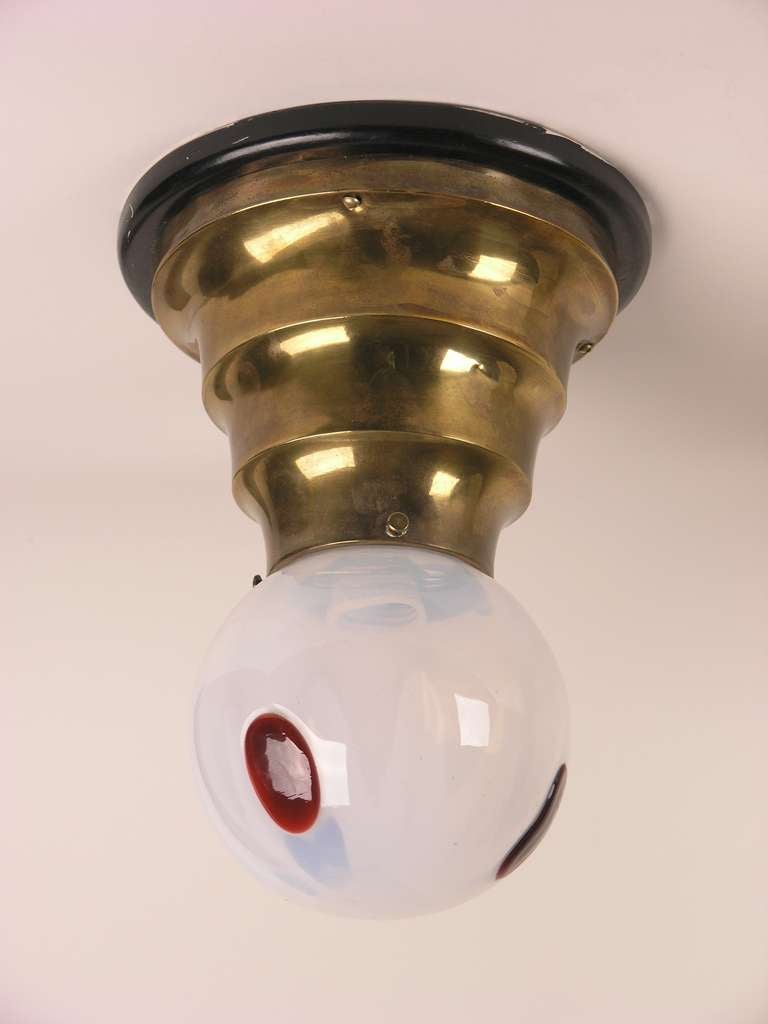 Stepped bulb socket in brass. Round lampshade in glass with elongated red dots.
Rewired, electrical system checked.