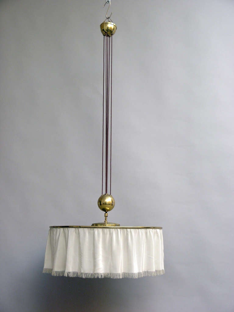 Functional height-adjustable pendant lamp in brass typical for the 1960ies. It is comparable with the lamp the architect Anna-Lülja Praun (1906-2004) used in one of her interiors in the begin of the 1970ies.  
Lit: Catalogue Anna -Lülja Praun,