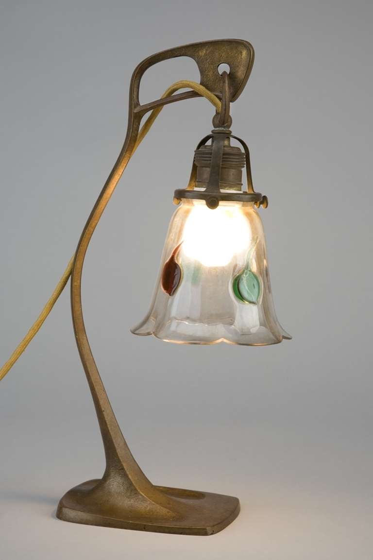 This table lamps is a representative example for the Viennese art nouveau style that was shown in Vienna at the first exhibitions of the Secession that was founded in 1897.
Original lamp shade with fused glass dots in green and red.