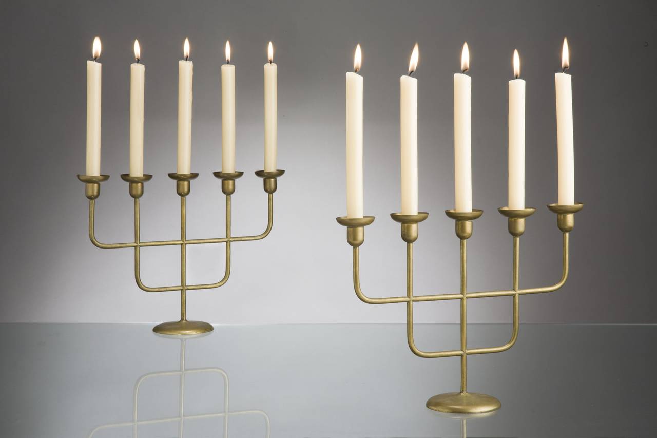 These two five-armed candleholders werde designed in Vienna in the 1950ies and are made of brass. Typical for works by Hagenauer is the reduction of form to its basics, dynamic shapes, the renouncement of all detail, and the optical play between two