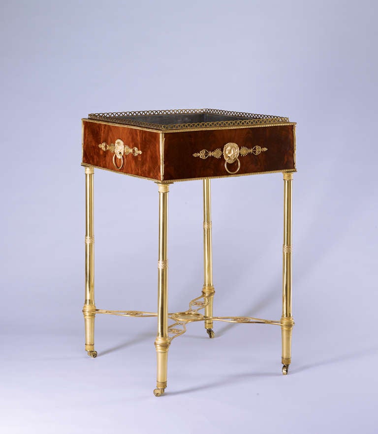 A fine and important gilt-bronze mounted German Empire mahogany jardiniere from the early 19th century. Of square from, with a pierced gilt-bronze gallery, above a frieze applied with central lion masks flanked by further Empire ornaments, removable