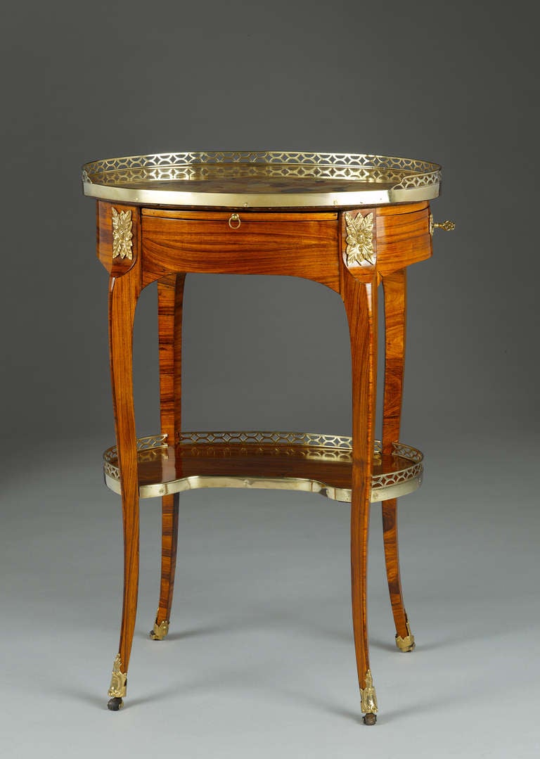 A fine ormolu-mounted and rosewood veneered gueridon à écritoire, stamped by the Parisian ébéniste Pierre-François Quéniard dit Guignard (1740-1794), became maître in 1767. He was a cabinet maker and renowned furniture merchant, established on the