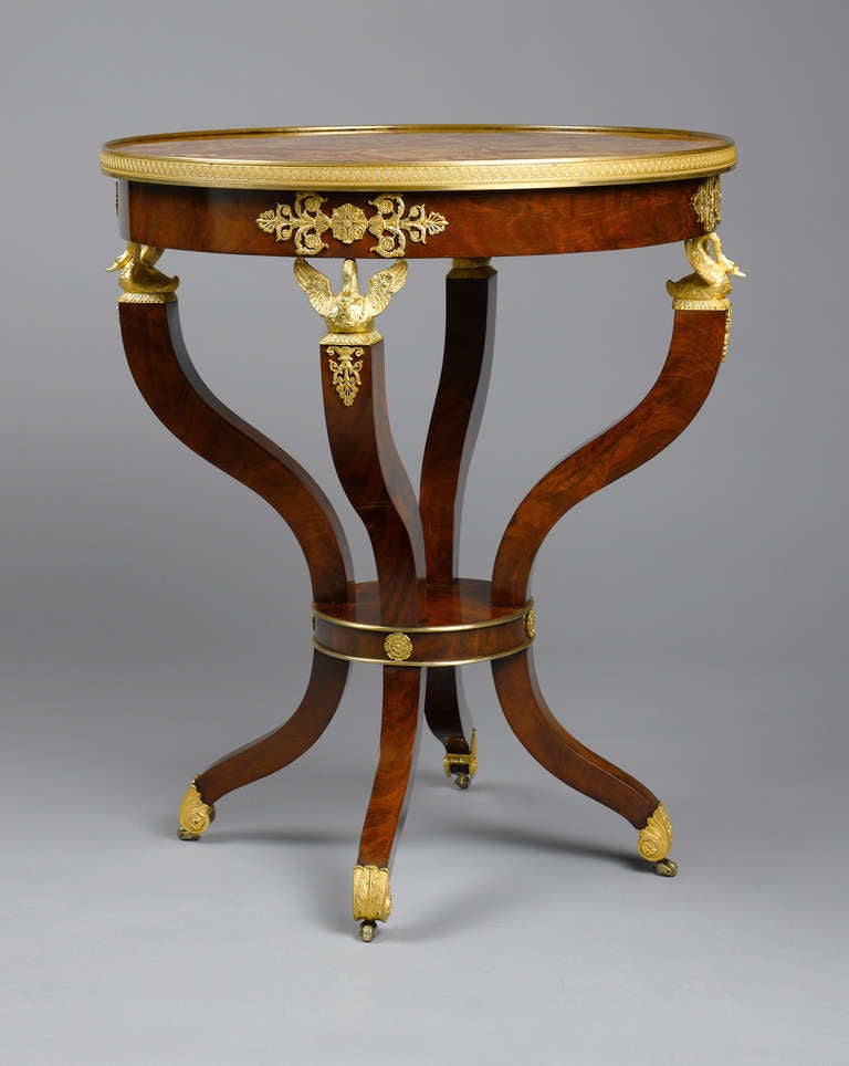 An unusual and spectacular Empire guéridon with very fine gilt-bronzes. Four sculptural ormolu swans support the circular table top, made of a marble mosaic of Diaspro di Sicilia veneered on stone. The swan, since antiquity an attribute of love,