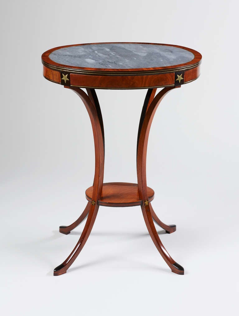 The oval grey marble insert top above a single frieze drawer, with brass line and star inlay, raised on slender curved legs joined by an oval undertier, ending on slipper feet; stamped CHAPUIS twice to the drawer interior, for Jean-Joseph Chapuis
