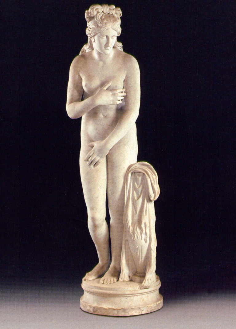 A fine Italian life-size white marble figure of the Capitoline Venus, after the Antique. The naked goddess covering her body with her hands, drapery resting on an urn by her side, standing on a circular waisted base. 

The Capitoline Venus was