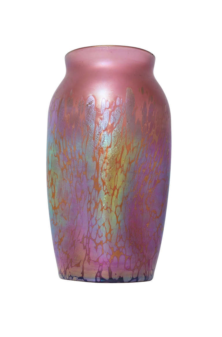 This vase is beatiful example of a creation of Loetz with the Medici decoration. The base colour is a rare rosé with a highly iridescent finish. The Silberkroeselzungen are splendit and they shimmer in a wide colour range from gold over tourquise to